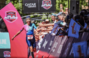 Lizzie Rayner running down the finish line high fiving the crowd at IRONMAN 70.3 Pays d'Aix Photo Credit: IRONMAN