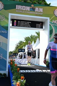 Loughlin Campion crosses the finish line of the 2025 IRONMAN World Championship